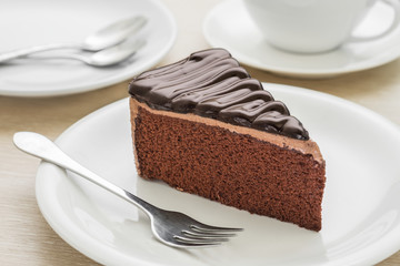 Chocolate cake on plate and coffee cup