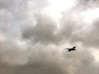 Fototapeta na wymiar airplane run away from cloudy storm 