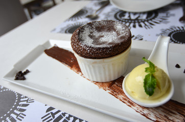 Hot Chocolate Souffle with Vanilla ice cream on a white plate