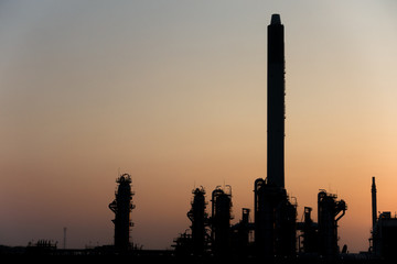 Silhouette Process Columns of Natural Gas Plant with sunrise sky in background