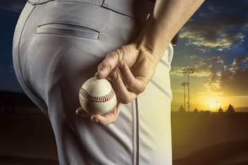 Baseball pitcher ready to pitch in an evening baseball game - obrazy, fototapety, plakaty