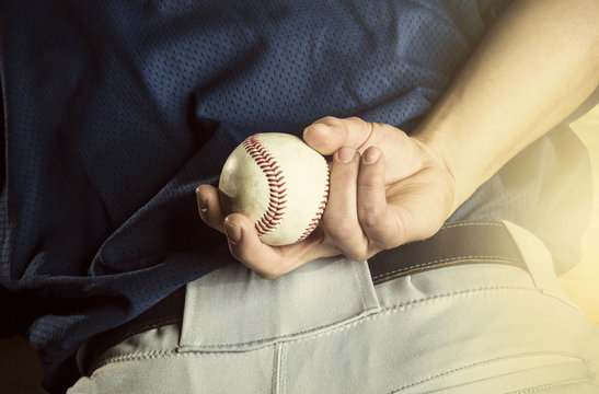 Baseball pitcher ready to pitch. Close up of hand focus on the fingers and the ball