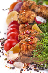 meatballs of fresh meat with herbs, tomato and vegetables