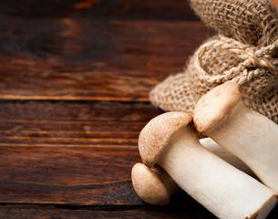 King trumpet mushrooms on a wooden background
