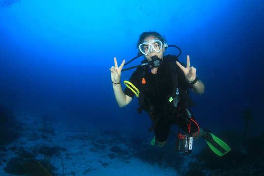 Scuba diver exploring coral reef