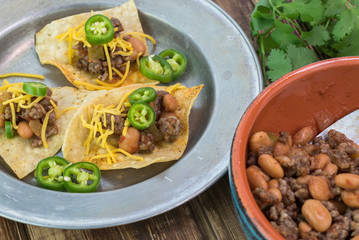 Homemade nachos with beef and pinto beans - ready to bake.
