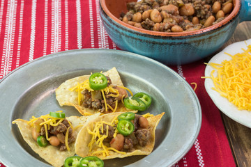 Homemade nachos with beef and pinto beans - ready to bake.