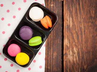 French colorful mini macarons on wood table