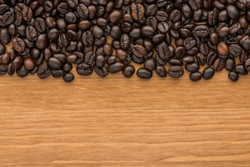 background of brown coffee beans on wood board