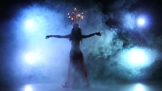 Belly dancer woman continue dancing with candles, head, black, smoke, slow motion, silhouette