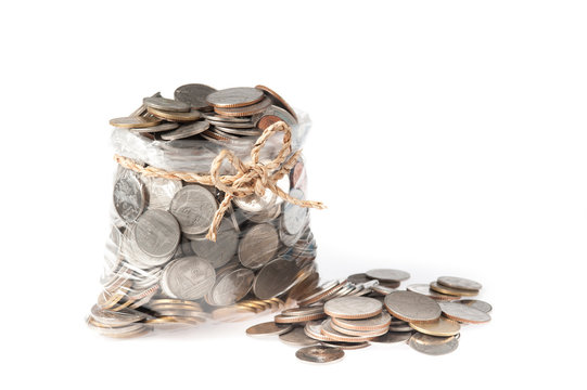 coins in plastic bags on white background