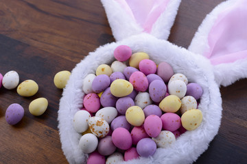 Fototapeta na wymiar Easter bunny ears with candy eggs