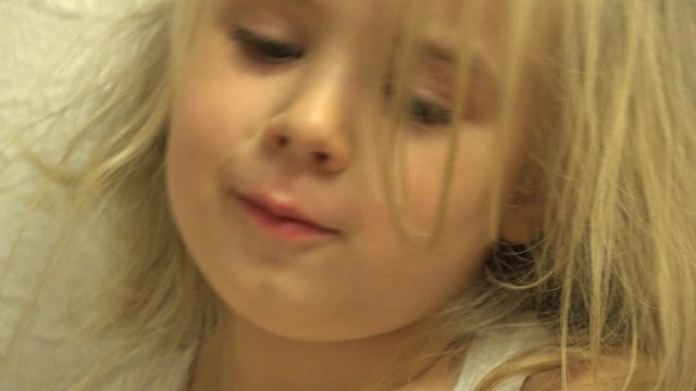 Closeup of Happy Baby Girl Grimace She's Face. 4K UltraHD video.
