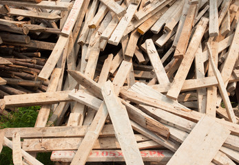 Pile of old and dirty lumber in construction site