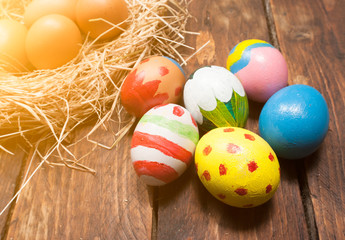 Easter eggs and hay on wooden background,morning light