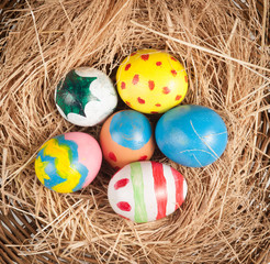 Easter eggs and hay on wooden background,morning light