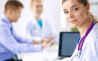 Medical team sitting at the table in modern hospital