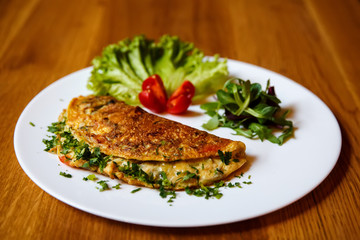 Herb omelette with chives and oregano sprinkled with chili flakes