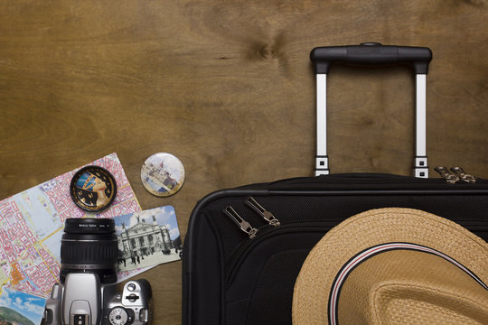 Traveler’s suitcase with  equipment with camera and pictures