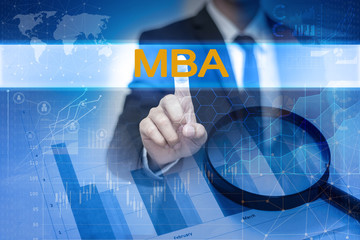 Businessman hand touching MBA button on virtual screen