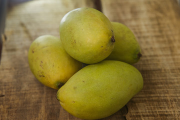 Closeup Four Mangos on Wooden Table