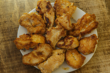 Top View Fried Pieces of Chicken Lying on White Plate