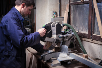 carpenter man using circular saw