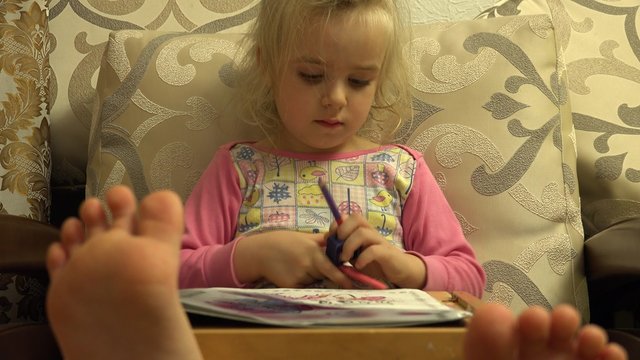 Cute Little Girl Paint Attentively, Big Leg in Frame. 4K UltraHD video.