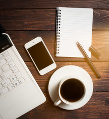 Office desk with laptop computer, notebook, mobile smartphone 
