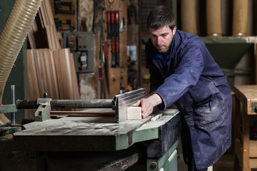 Carpenter man cutting wood with tablesaw