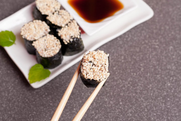 Sushi with sesame on a white plate