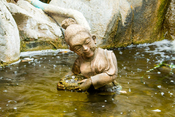 Fototapeta na wymiar Stone statue woman swim in the pool.