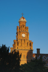 Fototapeta na wymiar Clock tower made from brown bricks of Chernivtsi Univercity