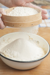 Women's hands preparing flour before baking pie