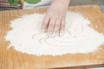 Women's hands preparing flour before baking pie