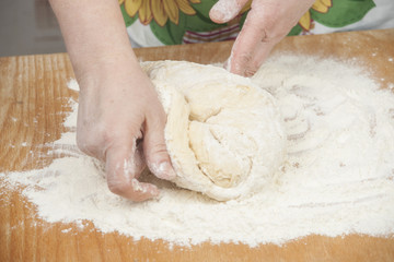 Women's hands prepairing fresh yeast dough