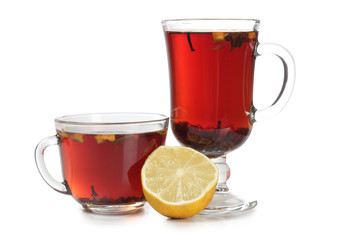 Glass cup with tea and a lemon on a white background
