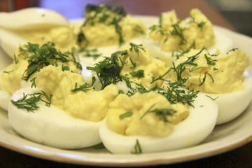 Boiled eggs sliced in halves stuffed and filling by pasta with d