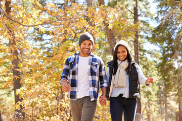 African American Couple Walking Through Fall Woodland