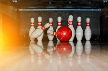 Ten white pins in a bowling alley with ball hit - obrazy, fototapety, plakaty