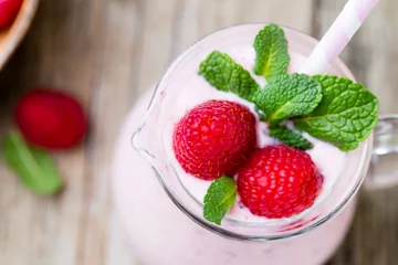 Keuken foto achterwand Milkshake Raspberry milk shake with mint decor.