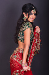 Asian model wearing indian dress on violet background at studio shoot