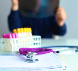 Medical doctor  sitting at table and looking patients roentgen