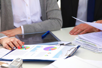 Image of business partners discussing documents and ideas at meeting