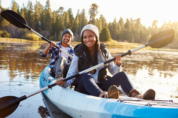 African American Couple Rowing Kayak On Lake - obrazy, fototapety, plakaty