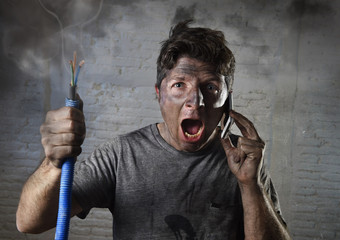 young man calling for help after accident with dirty burnt face in funny sad expression