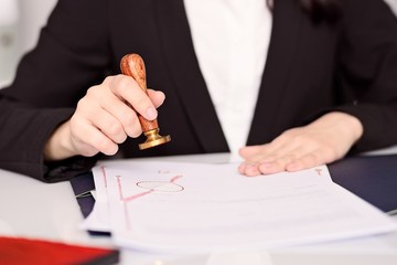 Notary Public woman hands stamping notary act .
