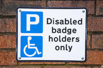 Parking sign for disabled people on outside wall