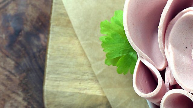 Portion of rotating sliced Mortadella as not seamless loopable 4K footage