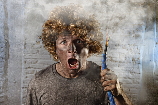 man with cable smoking after domestic accident with dirty burnt face shock electrocuted expression